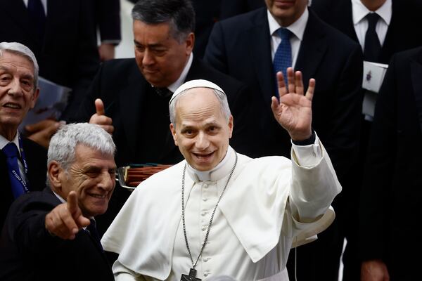 Pope Leo XIV waves to photographers during an audience in the Paul VI Hall at the Vatican on Monday, May 12, 2025, with members of the international media who covered the recent conclave in which he was elected. (Cecilia Fabiano/LaPresse via AP)
