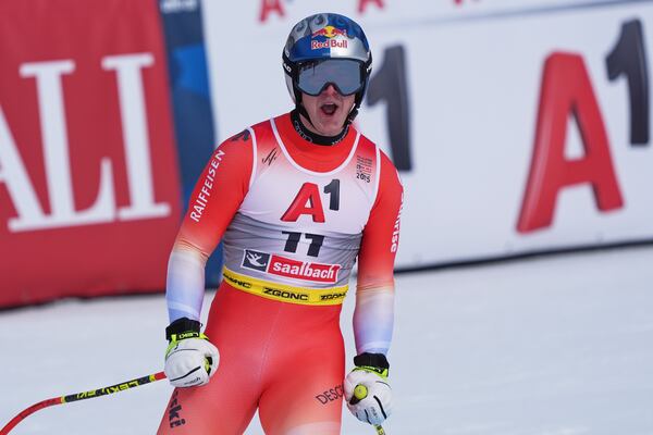 Switzerland's Franjo von Allmen celebrates at the finish area of a men's downhill race, at the Alpine Ski World Championships, in Saalbach-Hinterglemm, Austria, Sunday, Feb. 9, 2025. (AP Photo/Giovanni Auletta)