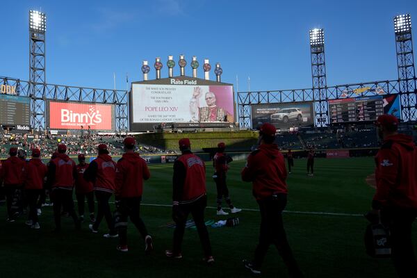 Chicago White Sox players walk on the field as the scoreboard honors Pope Leo XIV before a baseball game against the Miami Marlins, Friday, May 8, 2025, in Chicago. (AP Photo/David Banks)