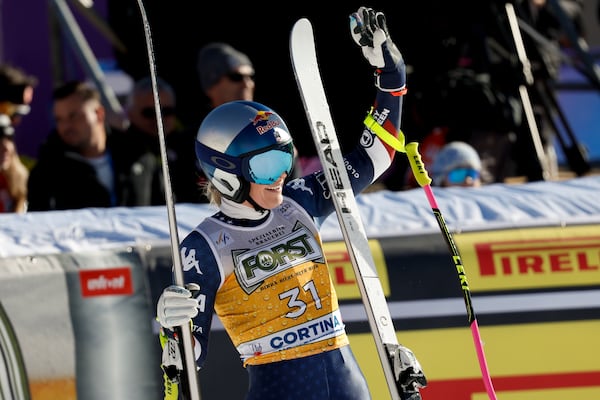 United States' Lindsey Vonn celebrates at the finish area of an alpine ski, women's World Cup downhill, in Cortina d'Ampezzo, Italy, Saturday, Jan. 18, 2025 (AP Photo/Alessandro Trovati)