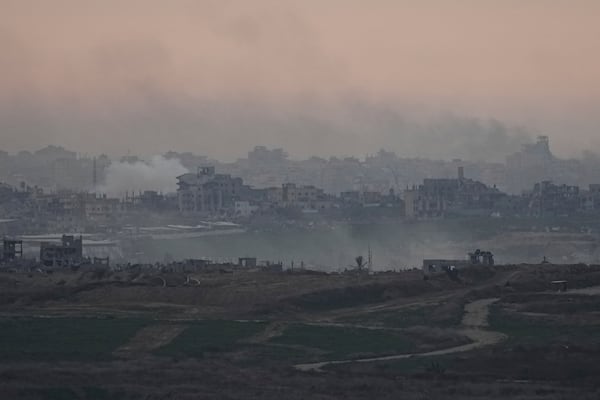 Destroyed buildings by Israeli bombardments are seen inside the Gaza Strip from southern Israel, on Tuesday, Jan. 14, 2025. (AP Photo/Tsafrir Abayov)