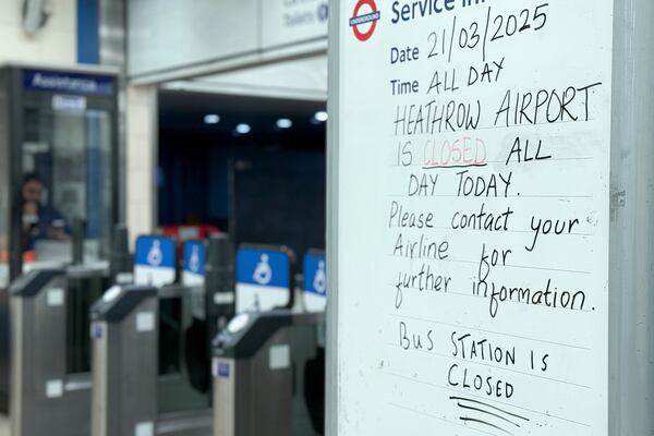 A handwritten sign at a Heathrow Airport tube station in London indicates the airport is closed on Friday March 21, 2025, following a fire at the North Hyde electrical substation the previous night.(AP Photo/Alberto Pezzali)