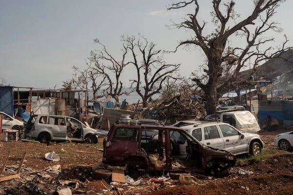 Broken cars are seen in Barakani, Mayotte, France on Saturday, Dec. 21, 2024. (AP Photo/Adrienne Surprenant)