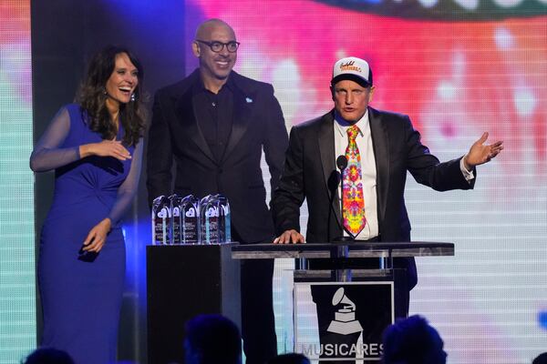 Laura Segura, from left, Harvery Mason Jr., and Woody Harrelson speak during the MusiCares Person of the Year gala honoring The Grateful Dead on Friday, Jan. 31, 2025, in Los Angeles. (AP Photo/Chris Pizzello)