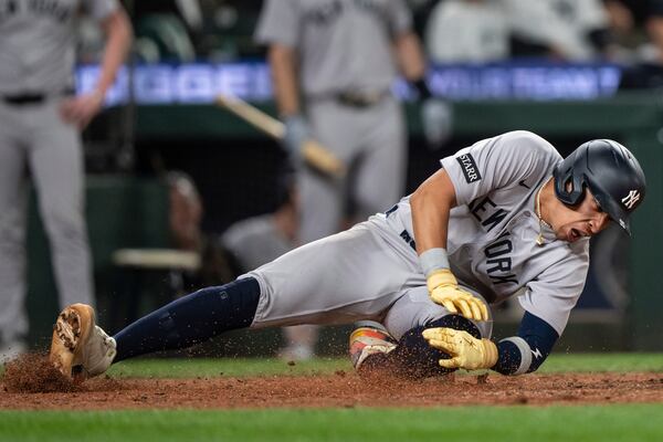 New York Yankees' Oswaldo Cabrera injures his leg while scoring a run during the ninth inning of a baseball game against the Seattle Mariners, Monday, May 12, 2025, in Seattle. (AP Photo/Stephen Brashear)