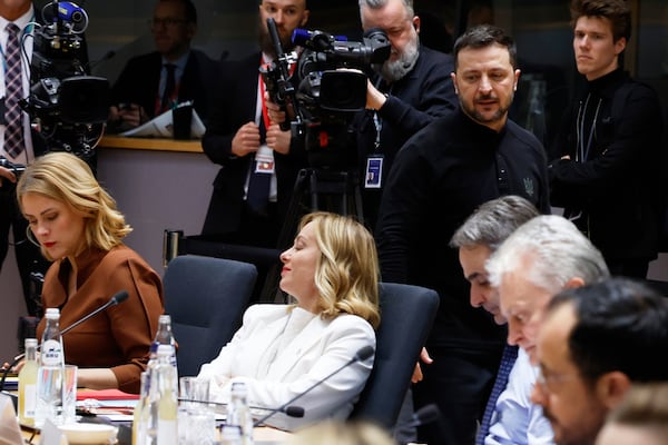 Ukraine's President Volodymyr Zelenskyy, center right, walks by Italy's Prime Minister Giorgia Meloni, center, during a round table meeting at an EU Summit in Brussels, Thursday, March 6, 2025. (AP Photo/Geert Vanden Wijngaert)