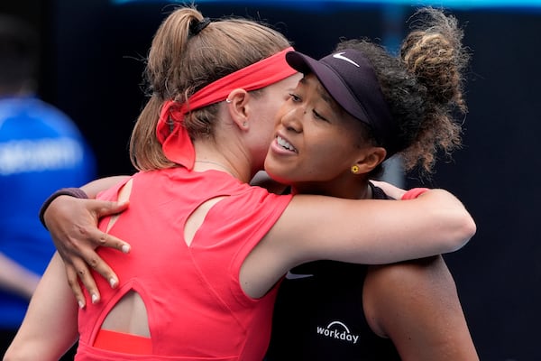 Naomi Osaka, right, of Japan is congratulated by Karolina Muchova of the Czech Republic following their second round match at the Australian Open tennis championship in Melbourne, Australia, Wednesday, Jan. 15, 2025. (AP Photo/Asanka Brendon Ratnayake)