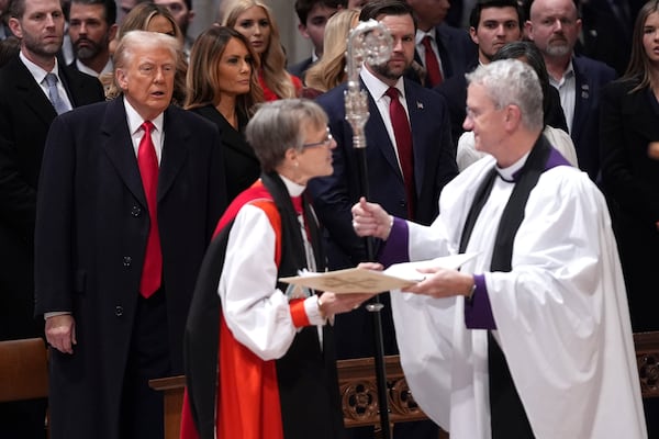 President Donald Trump, from left, watches as Rev. Mariann Budde arrives at the national prayer service at the Washington National Cathedral, Tuesday, Jan. 21, 2025, in Washington. (AP Photo/Evan Vucci)