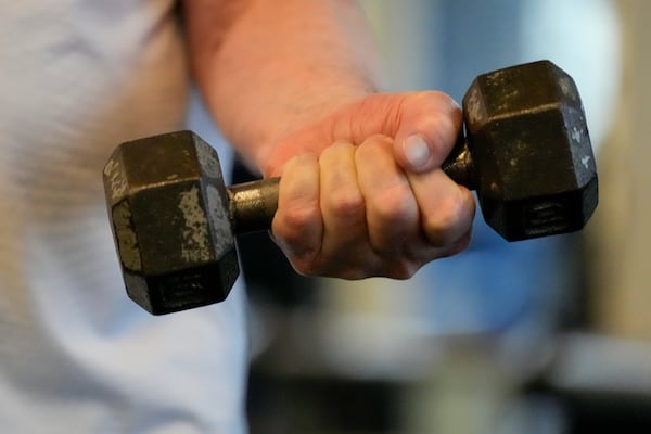 Dr. Grover Smith lifts a dumbbell at STEPS Fitness, Wednesday, Feb. 12, 2025, in Nashville, Tenn. (AP Photo/George Walker IV)