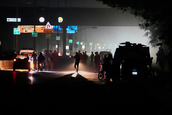 Pakistani police officers remove vehicles and people from the main entry of Nur Khan airbase following an Indian missile strike in Rawalpindi, Pakistan, Saturday, May 10, 2025. (AP Photo/Anjum Naveed)