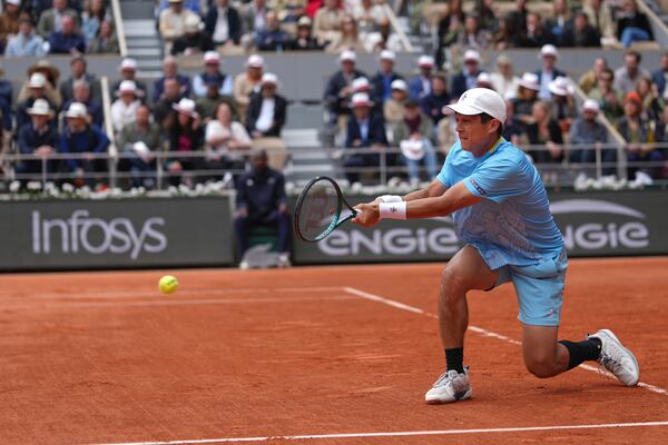 Mackenzie McDonald of the U.S. returns the ball to Serbia's Novak Djokovic during their first round match of the French Tennis Open, at the Roland-Garros stadium, in Paris, Tuesday, May 27, 2025. (AP Photo/Thibault Camus)