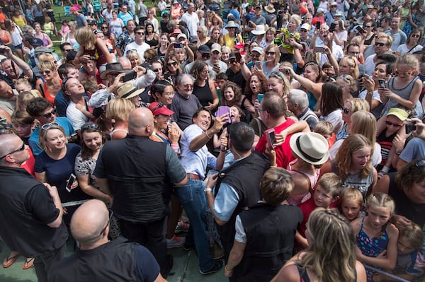 FILE - Prime Minister Justin Trudeau, centre left, takes a selfie with a person in a wheelchair during a visit to B.C. Day celebrations in Penticton, B.C., on Aug. 6, 2018. (Darryl Dyck/The Canadian Press via AP, File)