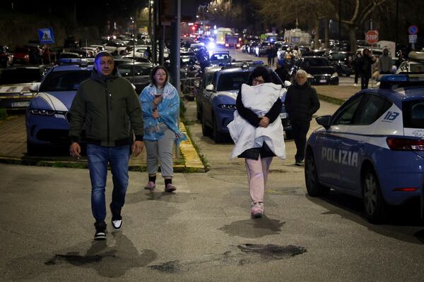 People seek safety in the streets following an earthquake north of Naples, Italy, Thursday, March 13, 2025. (Alessandro Garofalo/LaPresse via AP)