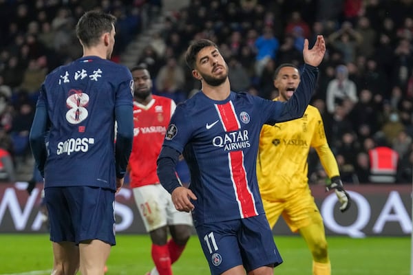 PSG's Marco Asensio, centre, reacts after missing a chance during the French League One soccer match between Paris Saint-Germain and Reims at Parc des Princes stadium in Paris, Saturday, Jan. 25, 2025. (AP Photo/Michel Euler)