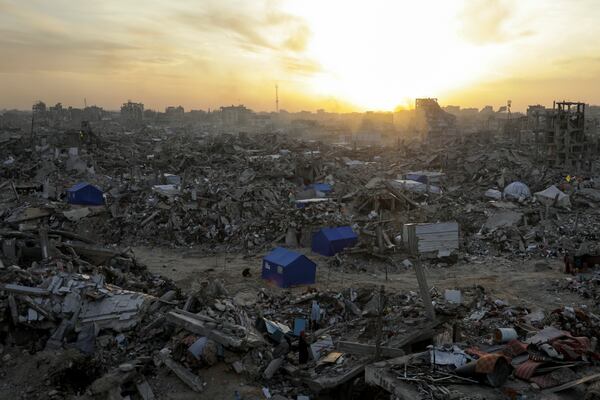 People walk amid the destruction caused by the Israeli air and ground offensive in Jabaliya, Gaza Strip, on Tuesday, Feb. 18, 2025. (AP Photo/Jehad Alshrafi)