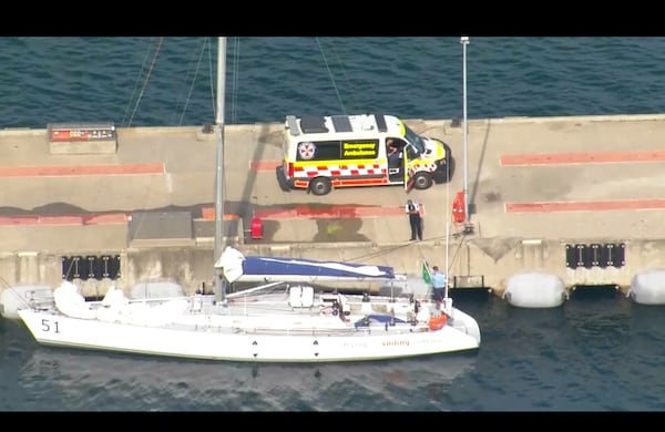 This image made from video provided by AUBC, CH9, CH7, CH9 shows sailing boat Flying Fish Arctos moored next to an ambulance at Jervis Bay, Australia, Friday, Dec. 27, 2024. (AUBC, CH9, CH7, CH9 via AP)