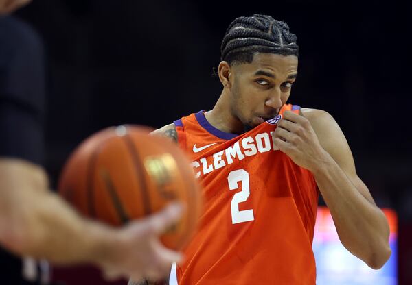 Clemson guard Dillon Hunter (2) wipes his face before shooting a free throw against Southern Methodist University during an NCAA college basketball game on Saturday, Feb. 22, 2025, in Dallas. (AP Photo/Richard W. Rodriguez)