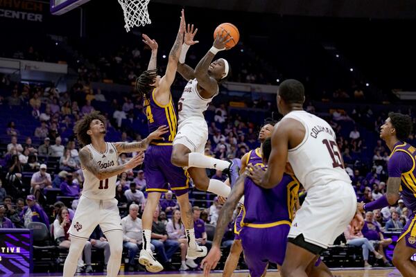 Texas A&M guard Manny Obaseki (35) shoots against LSU guard Dji Bailey (4) during the second half of an NCAA college basketball game in Baton Rouge, La., Saturday, March 8, 2025. (AP Photo/Matthew Hinton)