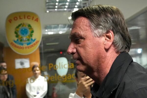 Former Brazilian President Jair Bolsonaro arrives for a luncheon with senators from his support base at the National Congress building in Brasilia, Brazil, Tuesday, Feb. 18, 2025. (AP Photo/Eraldo Peres)