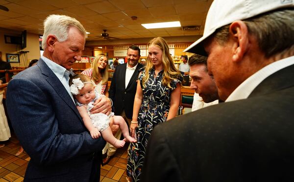 U.S. Sen. Tommy Tuberville, R-Ala., holds his granddaughter Rosie Grace Tuberville after he announced his plans to run for the governor of Alabama in 2026, Tuesday May 27, 2025 at Byron's Smokehouse in Auburn, Ala. (AP Photo/ John David Mercer)