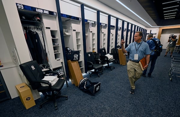 Members of the media look around the New York Yankees clubhouse during a tour of the upgraded team spring training facilities Thursday, Feb. 13, 2025, at George M. Steinbrenner Field in Tampa, Fla. (AP Photo/Steve Nesius)