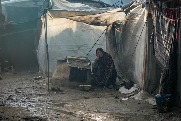 Samira Deifallah, 52, displaced from Gaza city, sits outside her tent after a night of heavy rainfall at a tent camp for displaced Palestinians in Deir al-Balah, central Gaza Strip, Thursday Jan. 23, 2025. (AP Photo/Abdel Kareem Hana)