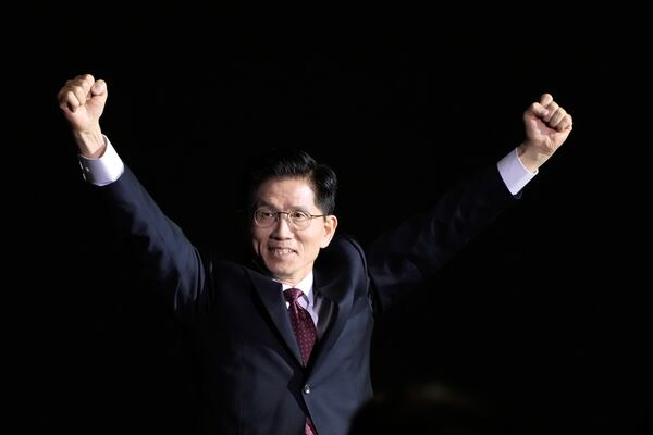 South Korea's former Labor Minister Kim Moon Soo raises his hands as he arrives to attend the People Power Party's convention in Goyang, South Korea, Saturday, May 3, 2025. (AP Photo/Ahn Young-joon)