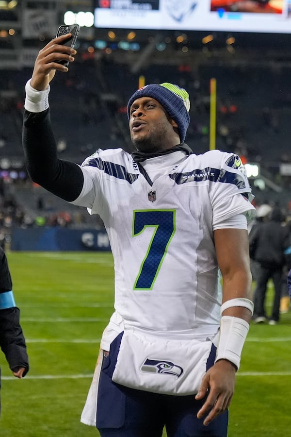 Seattle Seahawks quarterback Geno Smith (7) holds a cell phone following an NFL football game against the Chicago Bears, Thursday, Dec. 26, 2024, in Chicago. The Seahawks won 6-3. (AP Photo/Erin Hooley)