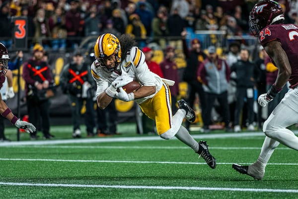 Minnesota wide receiver Elijah Spencer (11) dives in for a touchdown during the first half of the Duke's Mayo Bowl NCAA college football game Friday, Jan. 3, 2025, in Charlotte, N.C. (AP Photo/Robert Simmons)