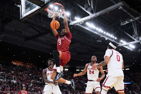 Arkansas forward Jonas Aidoo (9) dunks against St. John's during the second half in the second round of the NCAA college basketball tournament, Saturday, March 22, 2025, in Providence, R.I. (AP Photo/Charles Krupa)