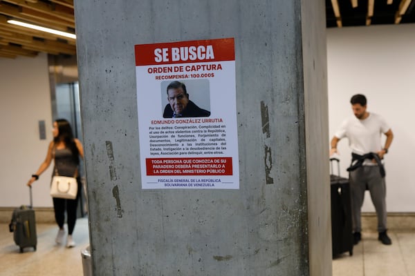 A wanted poster of Venezuela's opposition leader Edmundo Gonzalez covers a column at the Simon Bolivar International Airport in Maiquetia, near Caracas, Venezuela, Friday, Jan. 3, 2025. (AP Photo/Cristian Hernandez)