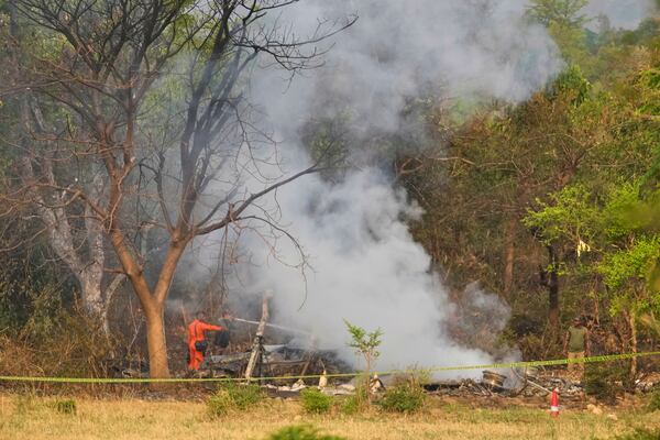 Fire fighters douse smoke coming out from the debris of an aircraft near Akhnoor on the outskirts of Jammu, India, Wednesday, May 7, 2025. (AP Photo/Channi Anand)