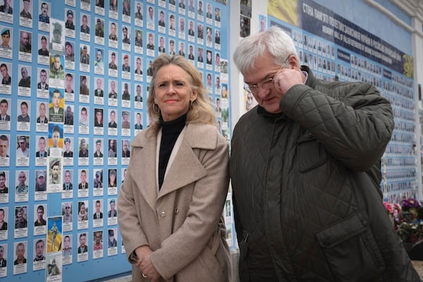 Iceland's Foreign Minister Thorgerdur Katrin Gunnarsdottir, left, and Ukraine's Foreign Minister Andriiy Sybiha attend a flower laying ceremony at the Memory Wall of Fallen Defenders of Ukraine in Kyiv, Ukraine, Tuesday, Jan. 7, 2025. (AP Photo/Efrem Lukatsky)