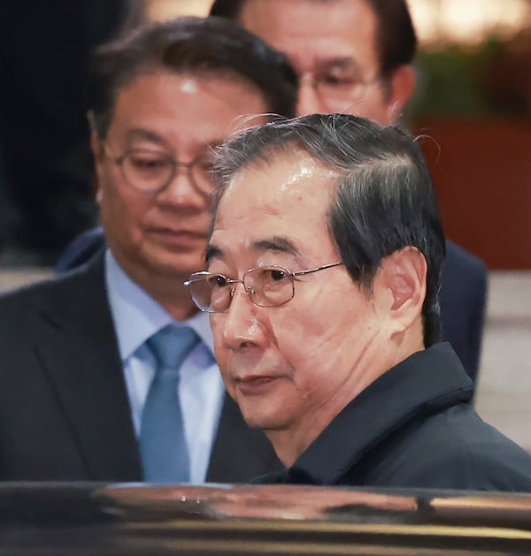 Impeached South Korean acting President Han Duck-soo gets into a car as he leaves the government complex building in Seoul, South Korea, Friday, Dec. 27, 2024. (Hong Hae-in/Yonhap via AP)