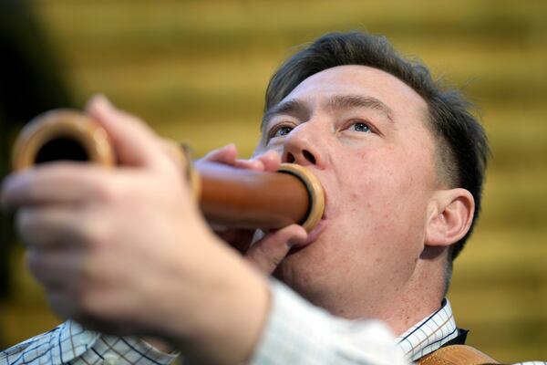 The winner Fabian Menzel performs to imitate a stag in heat during the German Championship of Deer-Calling at the hunting fair in Dortmund, Germany, Friday, Jan. 31, 2025. (AP Photo/Martin Meissner)