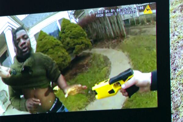 Body worn camera footage showing former Grand Rapids Police officer Christopher Schurr with a Taser7 and Patrick Lyoya is shown during the third day at the Kent County Courthouse with his wife Brandey in Grand Rapids, Mich. on Wednesday, April 30, 2025. (Joel Bissell/Kalamazoo Gazette via AP)