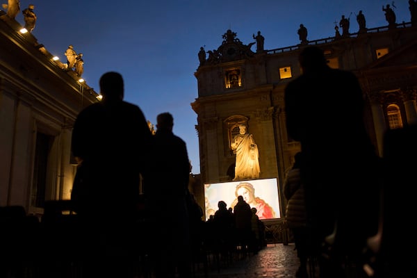 People attend a Rosary prayer for Pope Francis, in St. Peter's Square at the Vatican, Tuesday, March 11, 2025. (AP Photo/Francisco Seco)