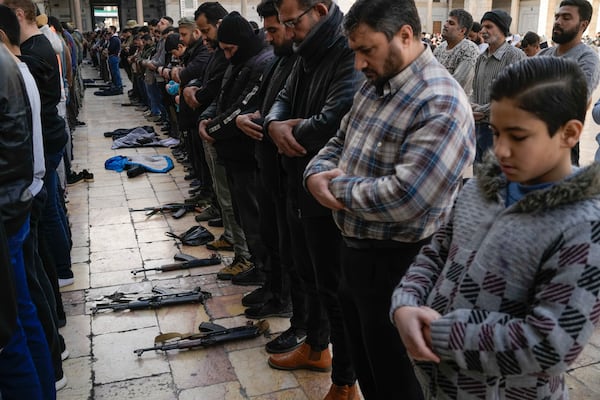 Syrians attend Friday prayers at the Umayyad Mosque, in Damascus, Syria, Friday, Dec. 20, 2024. (AP Photo/Leo Correa)