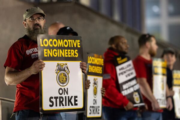 Union members from the Brotherhood of Locomotive Engineers and Trainmen form a picket line outside the NJ Transit Headquarters on Friday, May 16, 2025 in Newark, New Jersey. (AP Photo/Stefan Jeremiah)