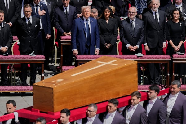 The coffin of Pope Francis is carried in front of dignitaries, including President Donald Trump, center, during his funeral in St. Peter's Square at the Vatican, Saturday, April 26, 2025. (AP Photo/Gregorio Borgia)