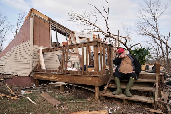 Tim Scott sits on the stairs of his home he was inside when it was destroyed during a severe storm the evening before Saturday, March 15, 2025, in Wayne County, Mo. (AP Photo/Jeff Roberson)