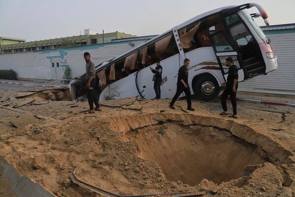 Palestinians inspect the site of an Israeli army airstrike on the European hospital in Khan Younis, Gaza Strip, Tuesday, May 13, 2025. The Israeli military said it had carried out a strike targeting what it said was a Hamas "command and control center" located beneath the hospital. (AP Photo/Mariam Dagga)
