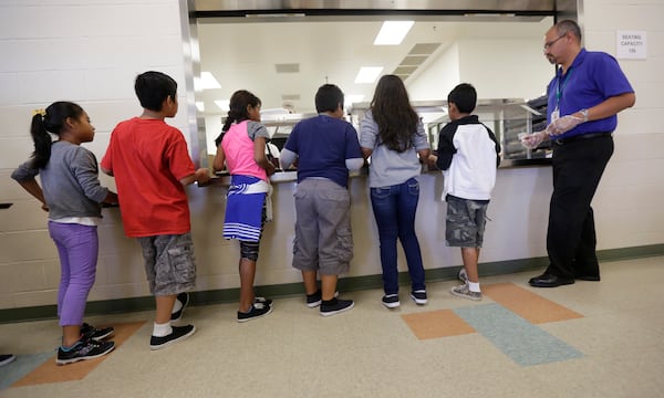 FILE - In this Sept. 10, 2014, file photo, detained immigrant children line up in the cafeteria at the Karnes County Residential Center, a detention center for immigrant families, in Karnes City, Texas. (AP Photo/Eric Gay, File)