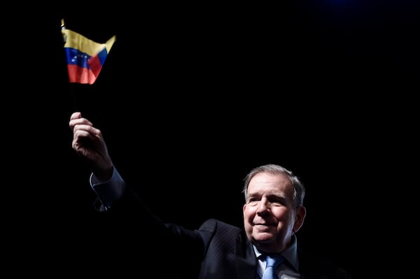 Venezuela's opposition leader Edmundo Gonzalez waves a Venezuelan flag during a meeting with supporters in Panama City, Wednesday, Jan. 8, 2025. (AP Photo/Agustin Herrera)