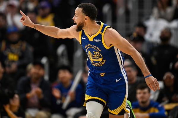 Golden State Warriors guard Stephen Curry (30) celebrates a three-point basket during the first half of an NBA basketball game against the Los Angeles Lakers, Wednesday, Dec. 25, 2024, in San Francisco. (AP Photo/Eakin Howard)