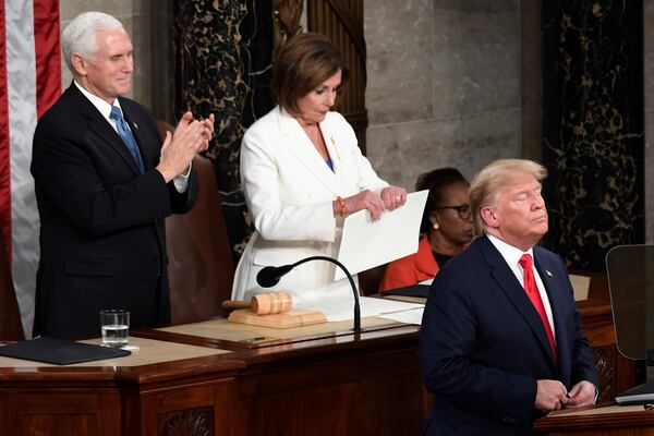 FILE - House Speaker Nancy Pelosi of Calif., tears her copy of President Donald Trump's s State of the Union address after he delivered it to a joint session of Congress on Capitol Hill in Washington, Feb. 4, 2020, as Vice President Mike Pence is at left. (AP Photo/Susan Walsh, File)