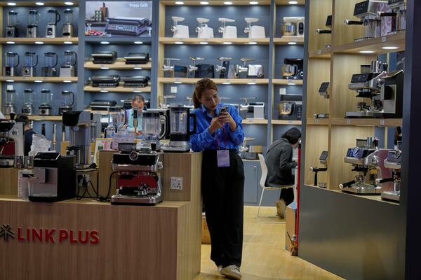 FILE - A vendor of coffee machines waits for customers at the 137th Canton Fair in Guangzhou, in southern China's Guangdong province on April 16, 2025. (AP Photo/Ng Han Guan, File)