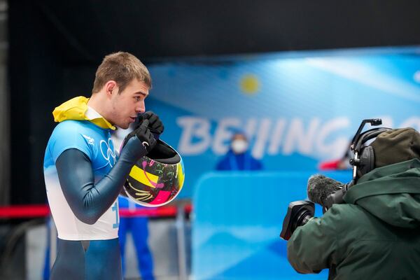 FILE - Vladyslav Heraskevych, of Ukraine, stands in the mixed zone after finishing the men's skeleton run 4 at the 2022 Winter Olympics, Friday, Feb. 11, 2022, in the Yanqing district of Beijing. (AP Photo/Mark Schiefelbein, File)