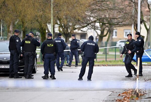 Police secure access to the elementary school where a 7-year-old girl died and a teacher and five other students were wounded in a knife attack in Zagreb, Croatia, Friday, Dec. 20, 2024. (AP Photo/Damir Krajac)