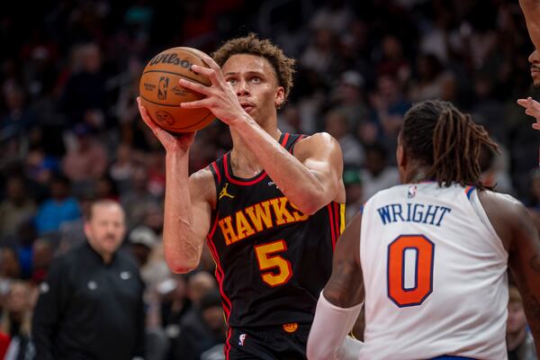 Atlanta Hawks guard Dyson Daniels (5) attempts to pass the ball as New York Knicks guard Delon Wright (0) defends during the second half of an NBA basketball game, Saturday, April 5, 2025, in Atlanta. (AP Photo/Erik Rank)